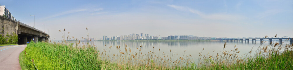 A beautiful park with a river and background of Seoul skyline. Day Cycling at Han Riverside