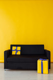 Fototapeta  - black sofa with gifts in the interior of the yellow room