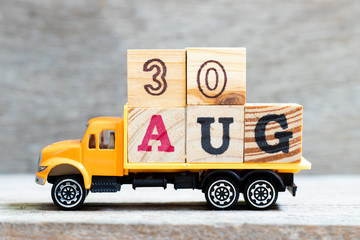 Sticker - Truck hold letter block in word 30aug on wood background (Concept for date 30 month August)