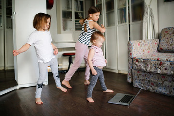 Three children dancing in video chat online