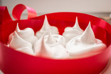 Homemade Meringue On A White Plate Decorated With A Red Ribbon