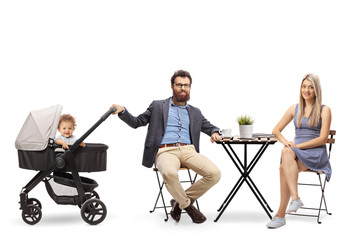 Poster - Young parents with a baby in a pushchair sitting at a table