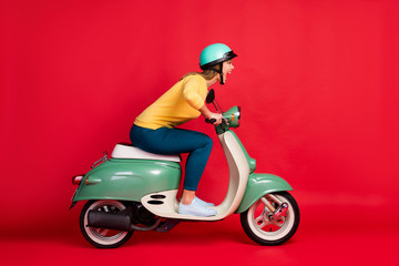 Naklejka na meble Profile side view portrait of her she nice attractive lovely crazy girlish cheerful cheery girl riding moped having fun adventure isolated on bright vivid shine vibrant red color background