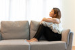© structuresxx - Depression and sadness concept,Young asian woman covering her face sitting on sofa in home.