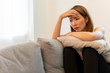 © structuresxx - Depression and sadness concept,Young asian woman covering her face sitting on sofa in home.