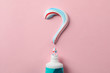 Question mark made of toothpaste and tube on pink background, copy space