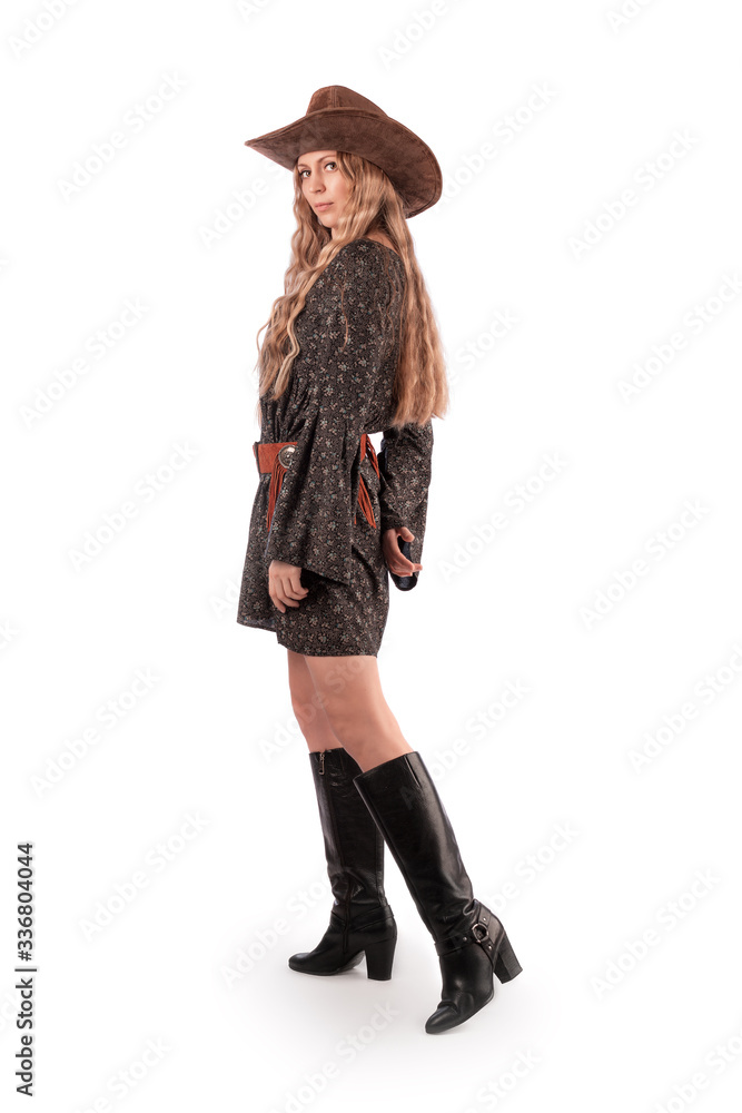 Girl in a rustic dress, black boots and a cowboy hat. Isolate on white ...