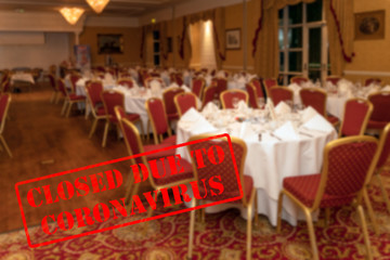 Defocused, blurred view of interior of an upmarket wedding venue or restaurant, empty and closed due to coronavirus or covid 19 pandemics