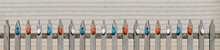 Red, Blue And White Easter Eggs Hang On Wooden Fence On Sunny Spring Day. Easter Banner