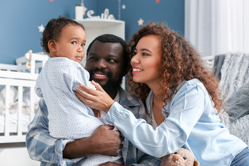 Sticker - Happy African-American parents with cute baby at home