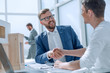© ASDF - architect shaking hands with the customer sitting at the table