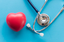 Directly Above Shot Of Heart Model With Stethoscope Over Blue Background