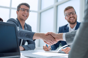 Wall Mural - close up. business people shaking hands at a meeting in the office