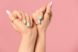 Hands of young woman with beautiful manicure on color background