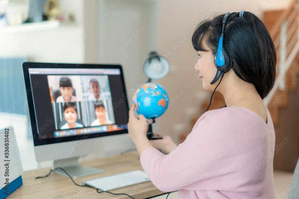 Asian woman teacher teaching geography via video conference e-learning and cheerful elementary school student looking at globe, Homeschooling and distance learning ,online ,education and internet.. - obrazy, fototapety, plakaty 