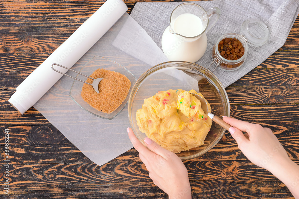 Woman preparing sweet dough, top view