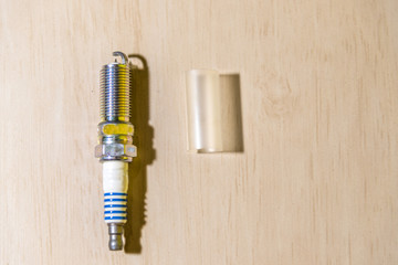 Automotive spark plug on light background