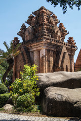 Old sacred red brick tower and two large grey stones