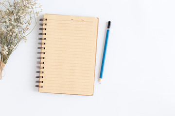 Wall Mural - blank notebook with and pencil on white background, flat lay photo of notebook for your message, top