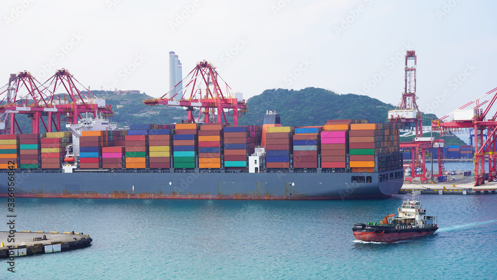 bright multi-colored containers on huge cargo barges in an industrial ...