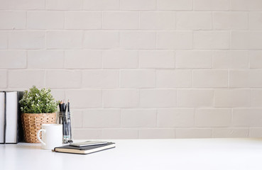 Wall Mural - Mockup workspace desk and copy space books,plant and coffee on white desk.
