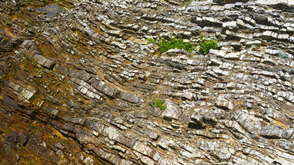 Stone texture, abstract background, uneven lines, bends of stone layers. Natural pattern for your product.wavy structure of layers of stone