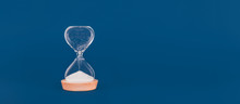 Hourglass With The Last Drops Of Sand. Concept Of Time And Timely Actions, Closing Opportunities. Wide Screen Banner Format With Place For Text