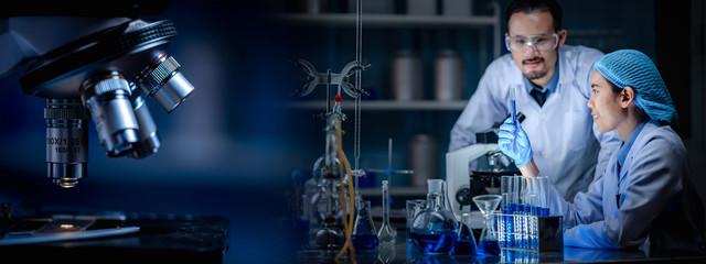 Wall Mural - banner background of scientist working in laboratory with test-tube and microscope