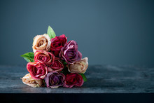 Artificial Antique Roses On Stony Background.