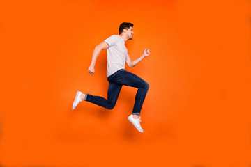 Sticker - Full length profile photo of attractive crazy youngster jump high rush sale shopping center addicted shopper wear striped t-shirt jeans shoes isolated bright orange color background