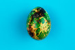 Easter egg painted green with gold.