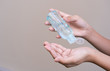 © parinya1990 - Asian girl kid using blue hand sanitizer gel in clear pump bottle , that use for killing germs, bacteria and viruses. Prevent the spread of germs and bacteria and avoid infections corona virus.