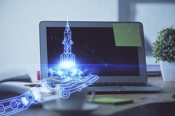Desktop computer background in office and start up theme hologram drawing. Double exposure. Startup concept.