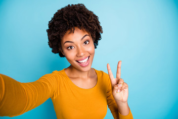 Canvas Print - Self-portrait of her she nice attractive lovely pretty charming cheerful cheery wavy-haired girl showing v-sign having fun isolated over bright vivid shine vibrant blue color background