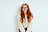Fototapeta Na drzwi - Smiling friendly young woman wearing spectacles