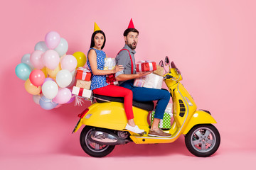 Poster - Full length profile side photo astonished two people bikers rider driver ride yellow scooter carry many gift boxes impressed incredible event have air balls fly isolated pink color background