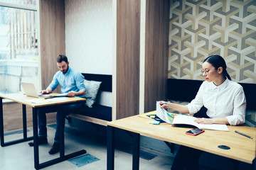 Wall Mural - Colleagues in casual clothes working in office at workplaces