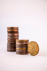 Two stacks of coins on a white background