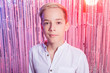 © satura_ - Awkward age and teenage concept - Portrait of teen boy at a party. Shiny background.