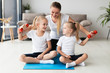 © FreepikCompany - Front view of mother and daughters exercising at home