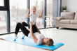 © FreepikCompany - Side view of happy mother and child exercising at home