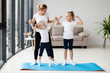 © FreepikCompany - Daughters exercising with mother at home