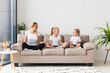 © FreepikCompany - Mother and daughters exercising at home on couch