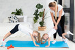 © FreepikCompany - Mother helping daughters exercise at home