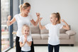 © FreepikCompany - Mother and daughters showing off they biceps at home