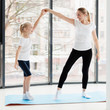 © FreepikCompany - Side view of mother and daughter exercising at home