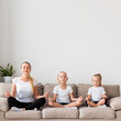 © FreepikCompany - Mother and daughters meditating on couch at home
