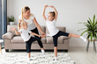 © FreepikCompany - Front view of daughters working out with mother at home