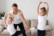 © FreepikCompany - Front view of mother helping daughter practice yoga at home