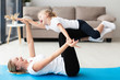 © FreepikCompany - Side view of happy mother and daughter at home on yoga mat
